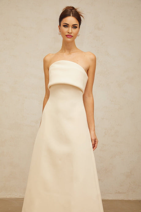 A white midi dress with a folded corset bodice and fitted silhouette named Raphaelle