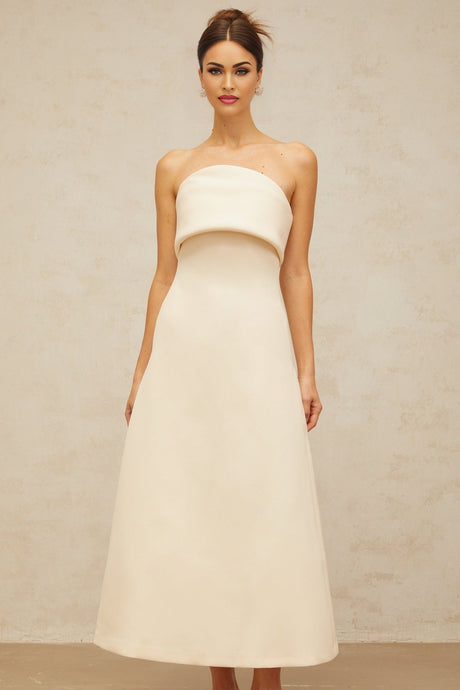 A white midi dress with a folded corset bodice and slim silhouette featuring a design by Raphaelle