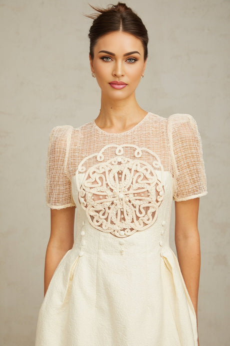 A white midi dress with braided details and panelling featuring a fitted silhouette and sleeveless design named Camille