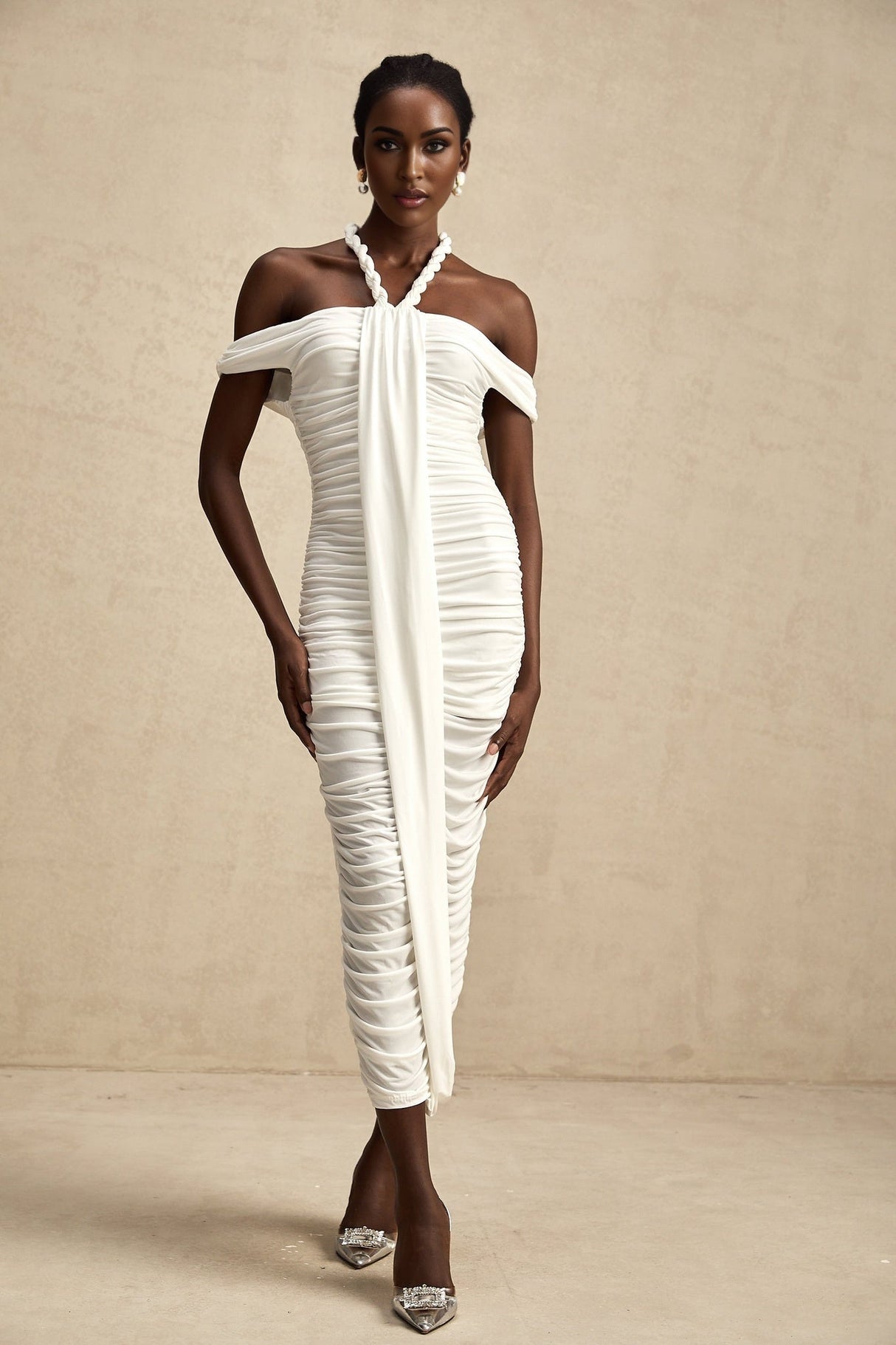 A white midi dress with braided rope detailing named Émeline