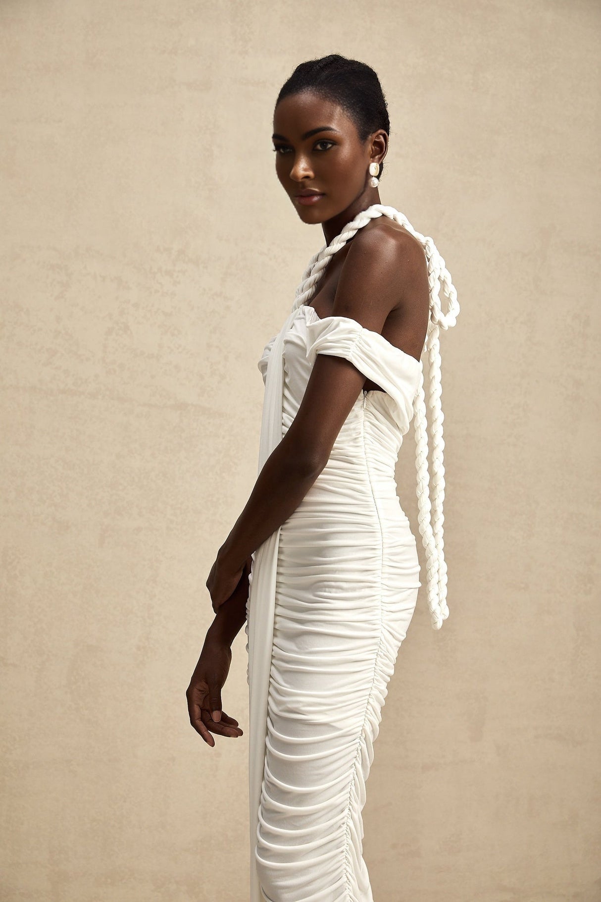 A white midi dress with braided rope detailing named Emeline