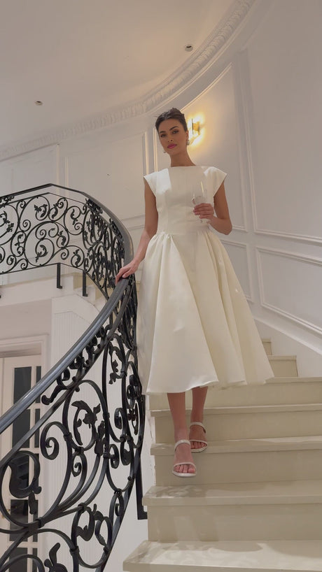 A white midi dress with cap sleeves and an open back named Amandine