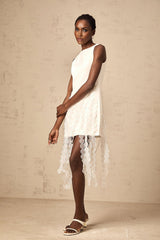 A white midi dress with circular disc designs and fringe detailing featuring short sleeves and a flowy silhouette named Justine