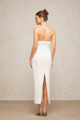 A white midi dress with corset styling and bow details named Isaline