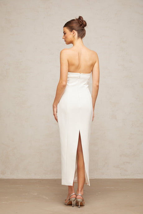 A white midi dress with corset styling and bow details named Isaline