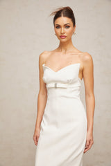A white midi dress with corsetstyle bodice and bow detail named Isaline