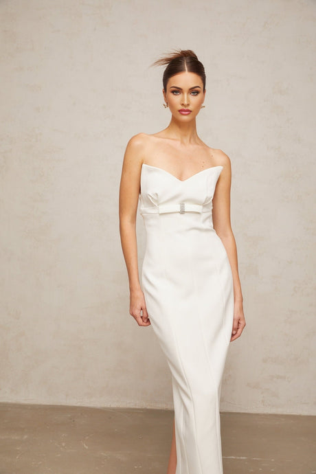A white midi dress with corsetstyle bodice and bow detail