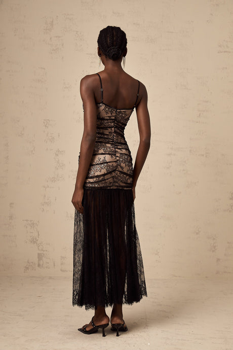 A white midi dress with floral embroidery lace detailing ruffled accents and a bustier style bodice