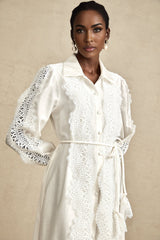 A white midi dress with lace details and a tied waist named Colette
