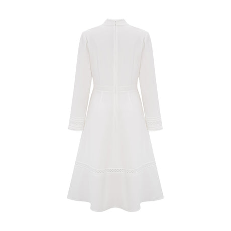 A white midi dress with panelled design and embroidery details named Madeleine featuring a feminine silhouette and delicate stitching throughout