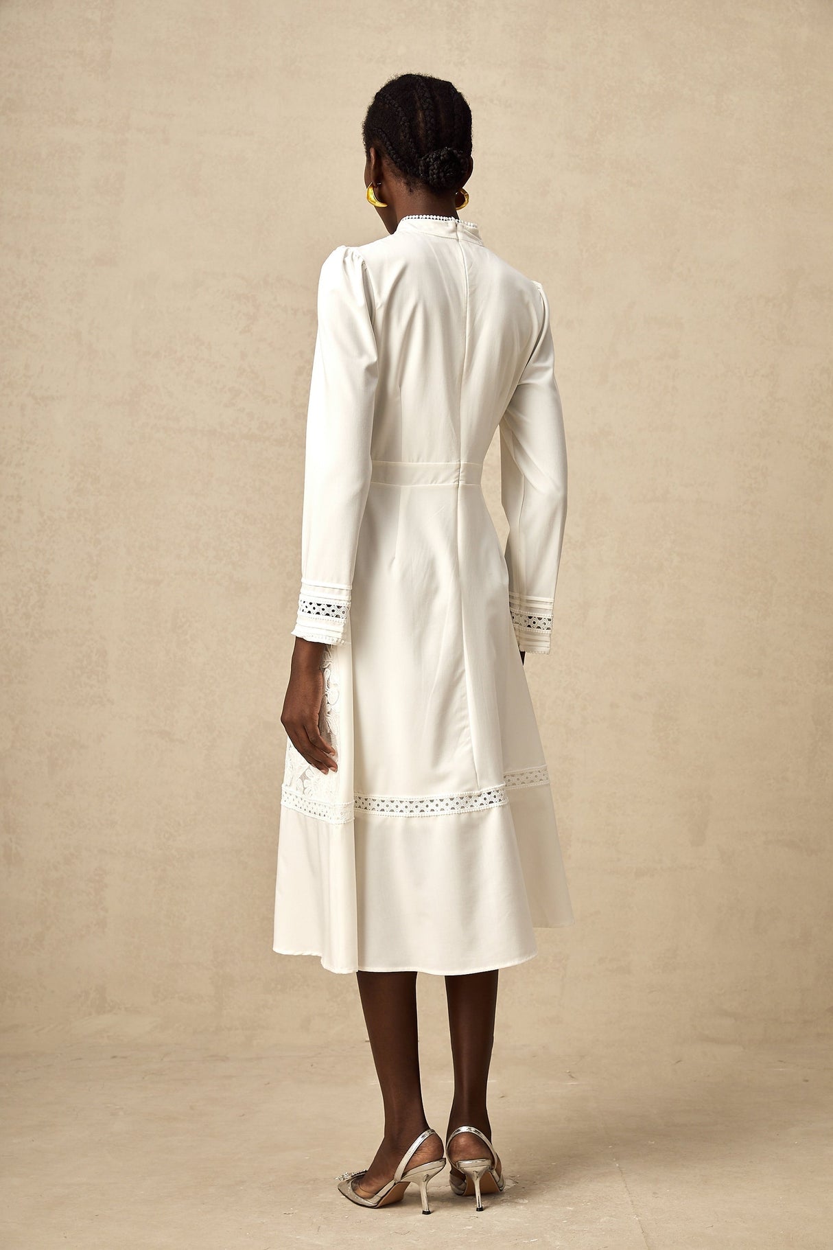 A white midi dress with panelled design and embroidery details named Madeleine featuring a feminine silhouette and delicate stitching throughout