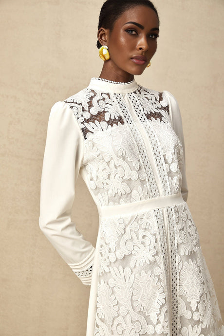 A white midi dress with panelled design and embroidery details named Madeleine featuring a feminine silhouette and delicate stitching throughout