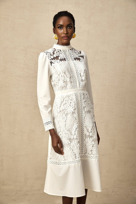 A white midi dress with panelled design and embroidery details named Madeleine featuring a feminine silhouette and delicate texture