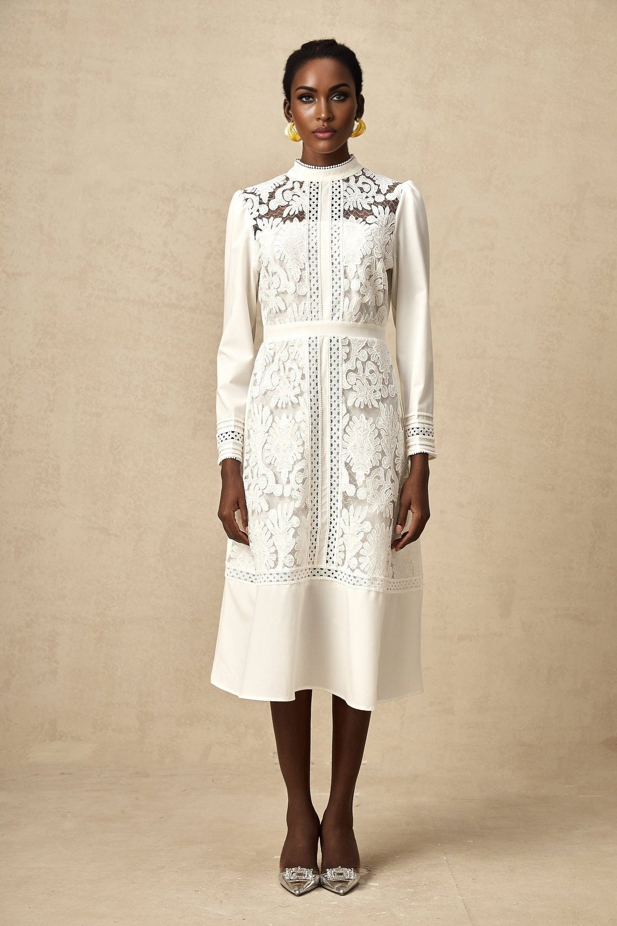 A white midi dress with panelled design and embroidery details named Madeleine featuring a fitted bodice and flared skirt