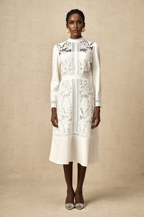 A white midi dress with panelled design and embroidery details named Madeleine featuring a fitted bodice and flared skirt