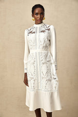 A white midi dress with panelled design and embroidery details named Madeleine featuring a fitted silhouette and delicate floral patterns