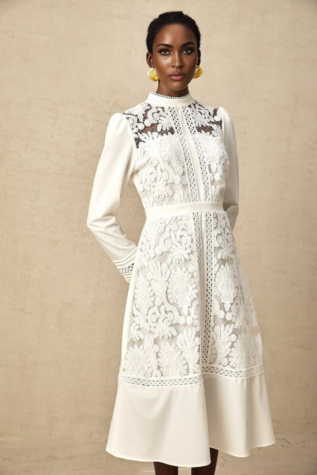 A white midi dress with panelled design and embroidery details named Madeleine featuring a fitted silhouette and delicate floral patterns