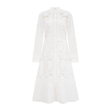 A white midi dress with panelled design and embroidery details named Madeleine featuring a fitted silhouette and delicate floral patterns