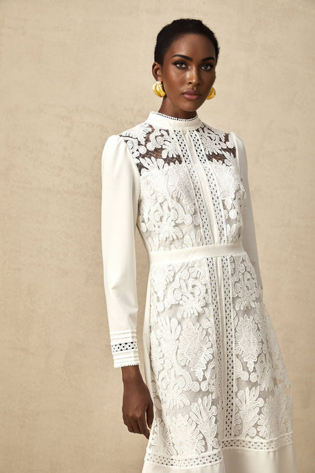 A white midi dress with panelled design and embroidery details named Madeleine featuring a fitted silhouette and delicate floral stitching throughout