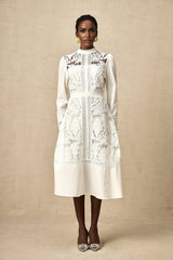 A white midi dress with panelled design and embroidery details named Madeleine featuring a fitted silhouette and delicate stitching patterns