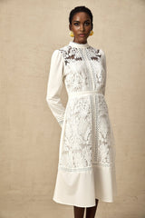 A white midi dress with panelled design and embroidery details named Madeleine featuring a fitted silhouette and delicate stitching throughout