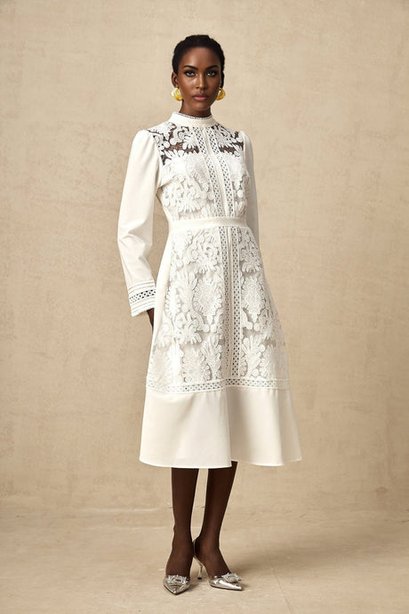 A white midi dress with panelled design and embroidery details named Madeleine featuring a fitted silhouette and delicate stitching throughout