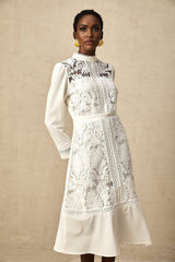 A white midi dress with panelled design and embroidery details named Madeleine featuring a fitted silhouette and feminine aesthetic