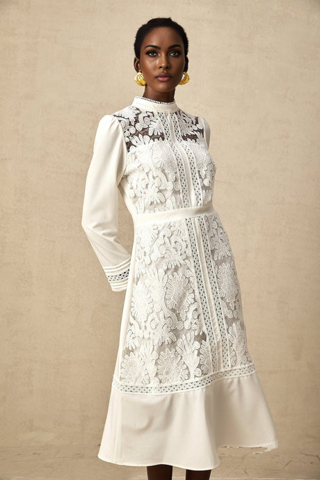 A white midi dress with panelled design and embroidery details named Madeleine featuring a fitted silhouette and feminine aesthetic