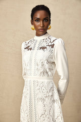 A white midi dress with panelled design and embroidery details named Madeleine featuring a sleek silhouette and delicate stitching patterns