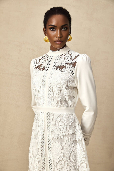 A white midi dress with panelled design and embroidery details named Madeleine featuring a sleek silhouette and delicate stitching patterns