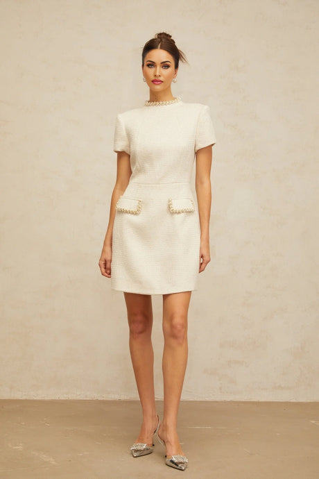 A white mini dress made of embellished tweed fabric with a feminine silhouette named Jeanne