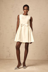 A white mini dress with a bow detail named Isabelle