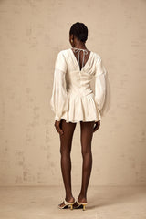 A white mini dress with a bowknot detail and glitter accents named Lina