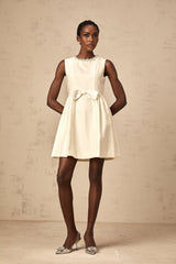 A white mini dress with a bowknot embellishment named Isabelle