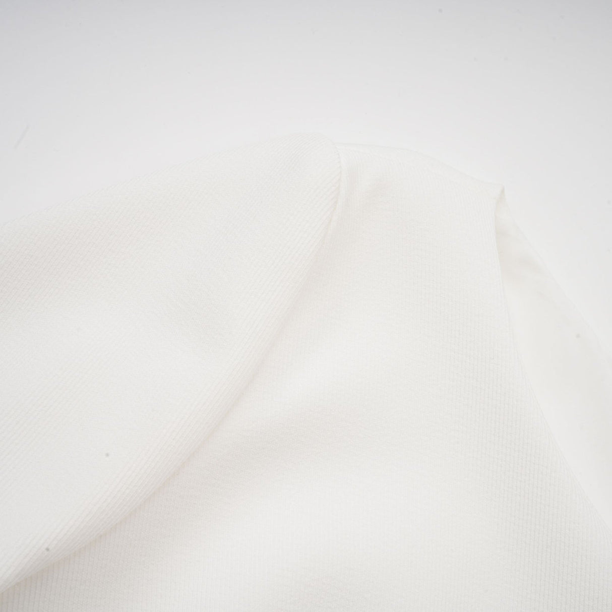 A white mini dress with a bubble skirt named Elodie featuring a fitted bodice and voluminous short skirt