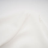 A white mini dress with a bubble skirt named Elodie featuring a fitted bodice and voluminous short skirt