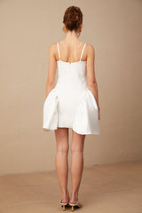 A white mini dress with a bustier style top featuring a delicate floral pattern throughout the fabric