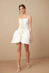 A white mini dress with a bustier top featuring a floral motif pattern throughout the fabric