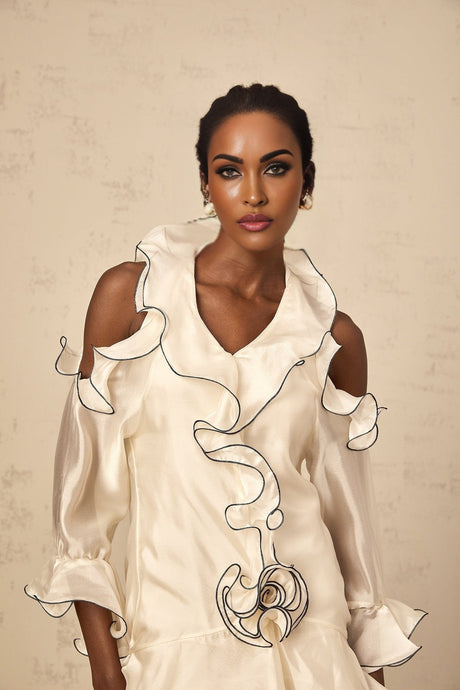 A white mini dress with a flounce design and ribbon details named Tiphaine