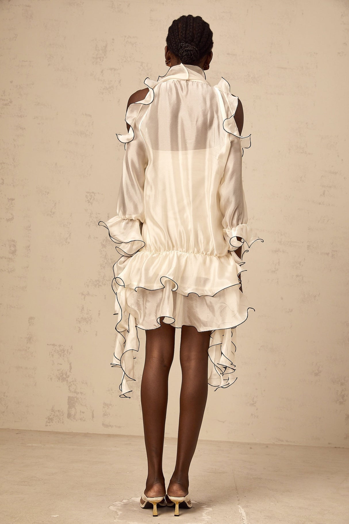 A white mini dress with a flounced skirt and ribbon details named Tiphaine