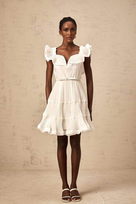 A white mini dress with a frilled neckline and pleated design named Éliane
