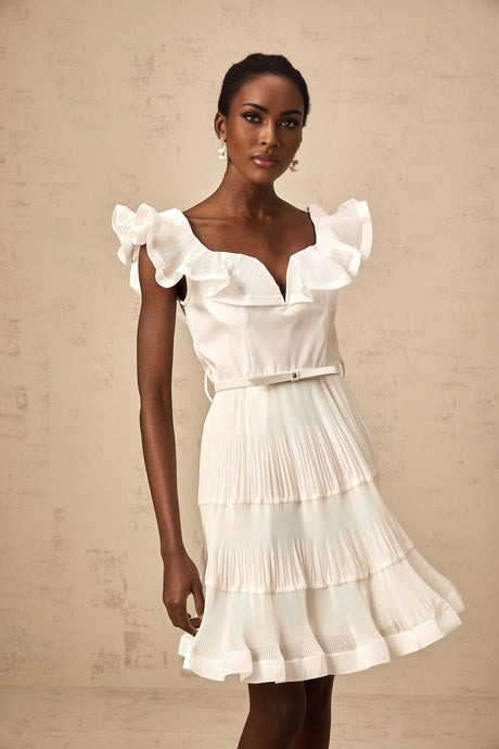 A white mini dress with a frilled neckline and pleated design named Eliane