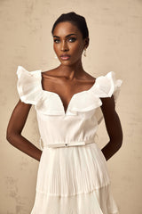 A white mini dress with a frilled neckline and pleated design named Eliane