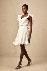 A white mini dress with a frilled neckline and pleated skirt named Eliane