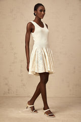 A white mini dress with a jacquard knit pattern named Eleonore featuring a short length and textured fabric design