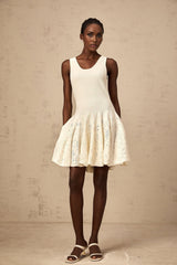 A white mini dress with a jacquard knit pattern named Eleonore worn by a model standing against a plain background