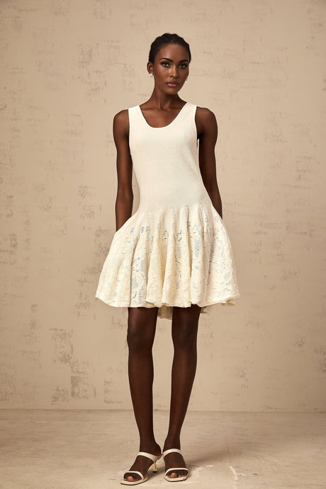 A white mini dress with a jacquard knit pattern named Eleonore worn by a model standing against a plain background