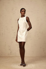 A white mini dress with an Aline silhouette featuring embellishments and a short hemline called the Flavie dress