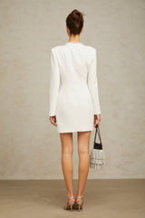 A white mini dress with an asymmetric hemline featuring a bowknot detail named Colette