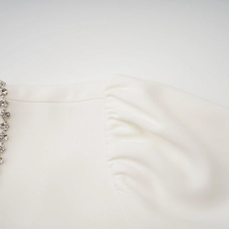 A white mini dress with crystal embellishments named Berenice